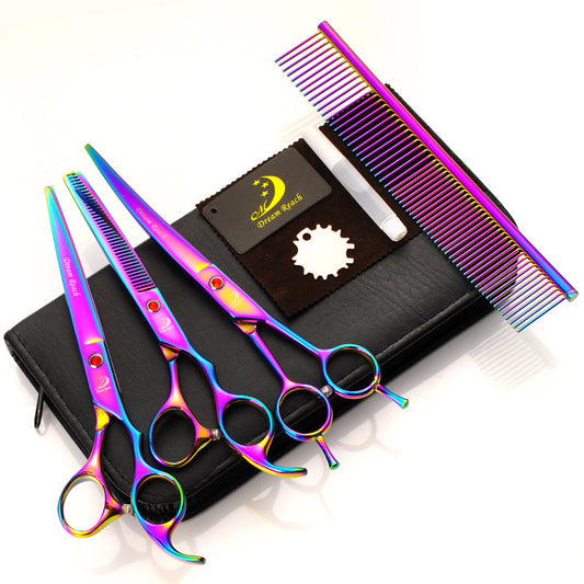 Set of colorful hair cutting scissors and comb on a white background